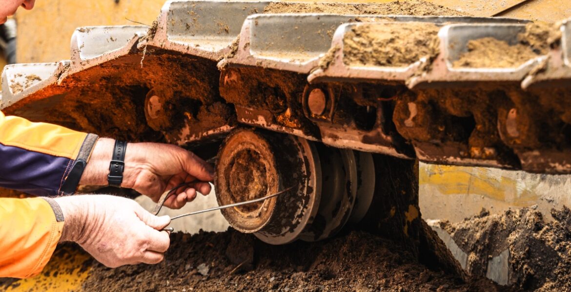 West-Trak technician performing track wear measurement on site.